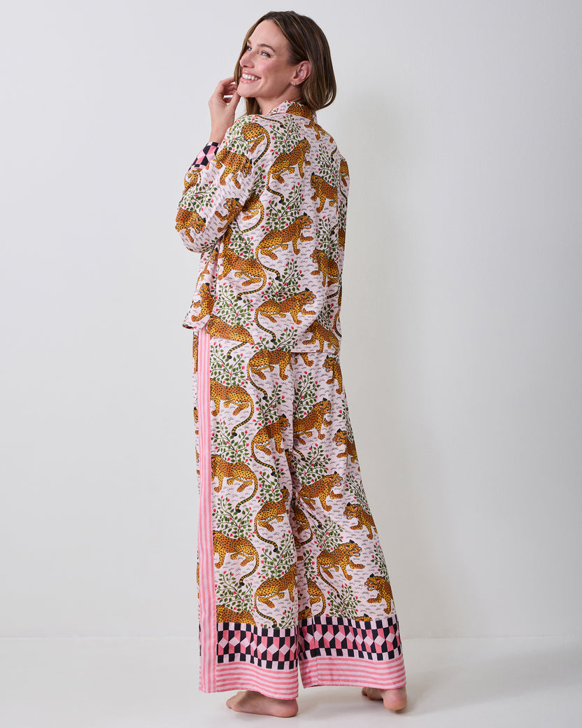 Back three-quarter view of the Bagheera blush pajama set on a model, showing the printed top and wide-leg pants with contrasting hem trim.