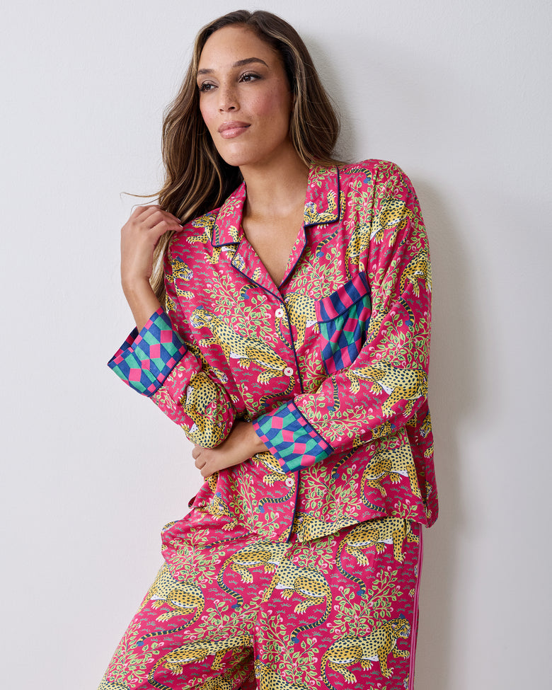 Person wearing the hot pink Bagheera pajama set with leopard-and-vine print, patch pocket, and contrasting cuffs.