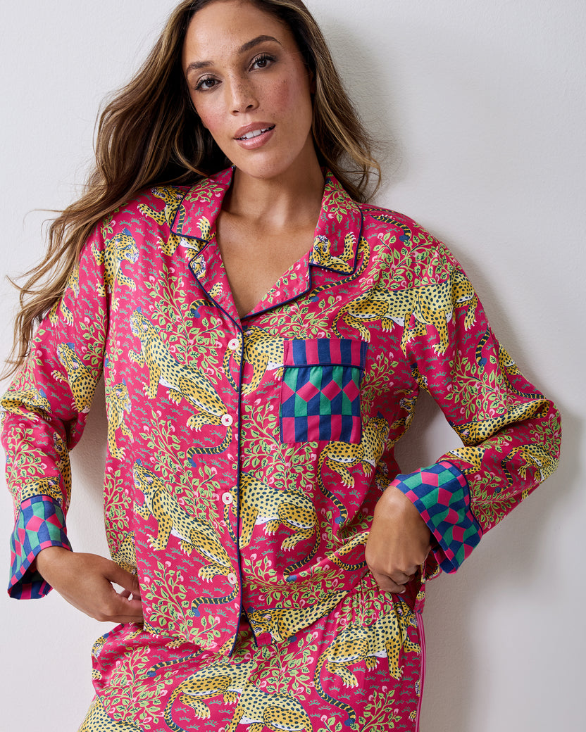 Front view of the hot pink Bagheera pajama set with leopard-and-vine print, button-front top, chest pocket, and contrasting cuffs.