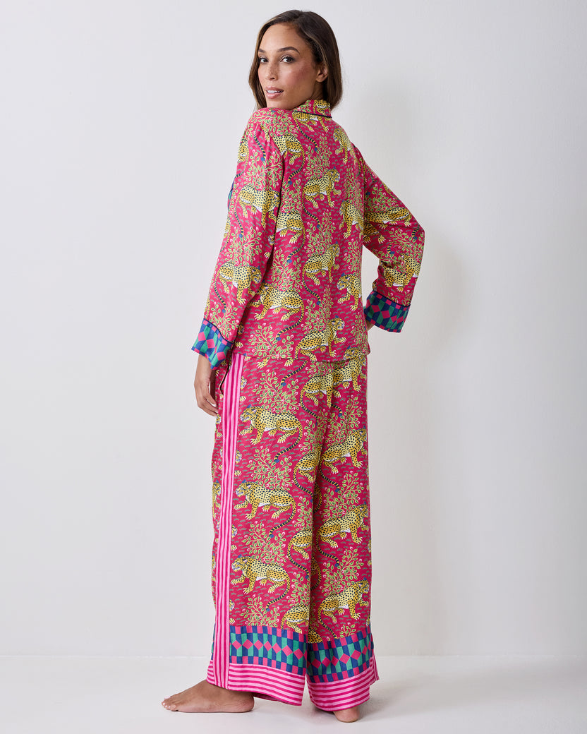 Back view of the hot pink Bagheera pajama set showing the leopard-and-vine print, long sleeves, wide-leg pants, and contrasting hems.
