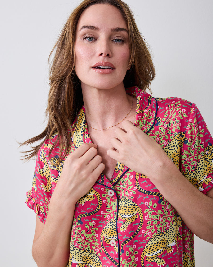 Close-up of the hot pink Bagheera pajama top showing the leopard print, collar, piping, and buttons.
