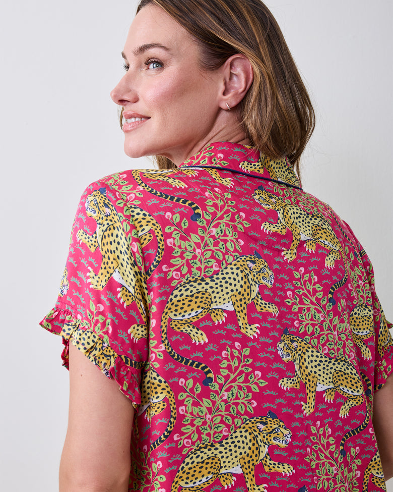 Close-up of the hot pink Bagheera pajama top from the back, showing the leopard print, collar, and layered ruffled sleeve trim.