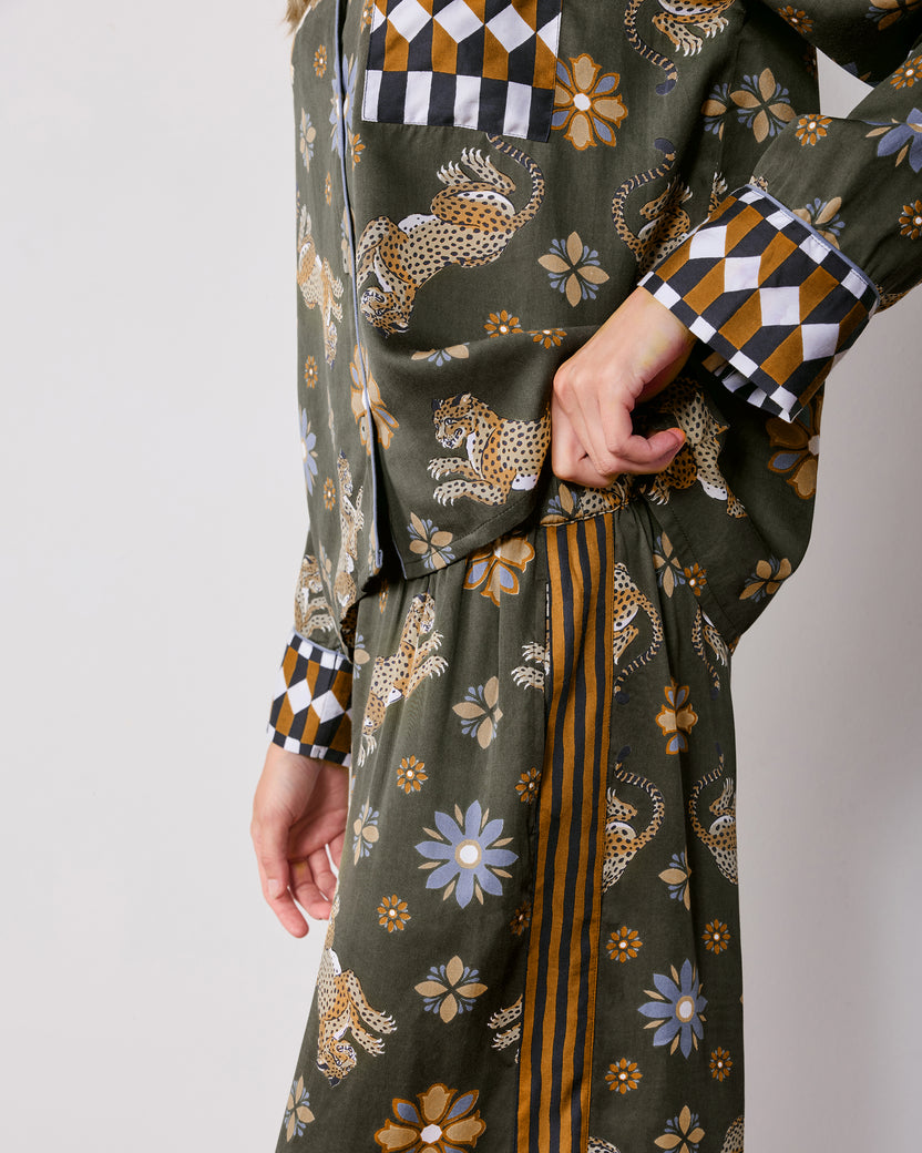 Side detail of the Rittenhouse set showing the top's geometric-print cuff and pocket beside the matching pants' striped side panel and elastic waistband.