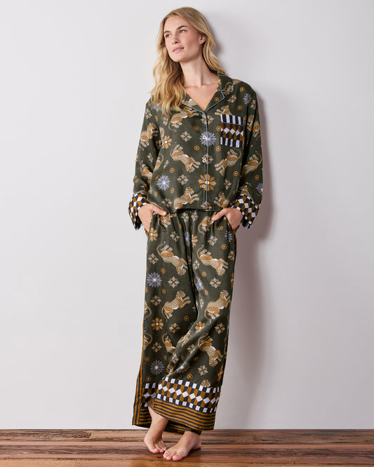 Front view of the olive Rittenhouse pajama set with a long-sleeve button-front shirt and wide-leg pants, featuring a leopard and flower print with checkerboard trim.