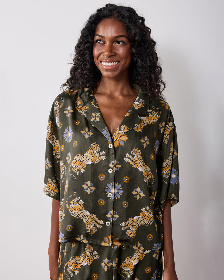 Front view of the olive Wildest Dreams pajama set with a short-sleeve notched-collar shirt and matching pants, featuring a leopard and flower print.