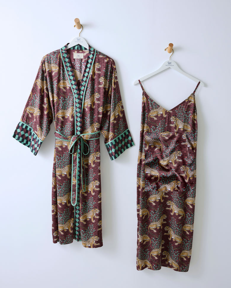 Raisin robe with contrasting trim and matching leopard-print nightie hanging side by side.