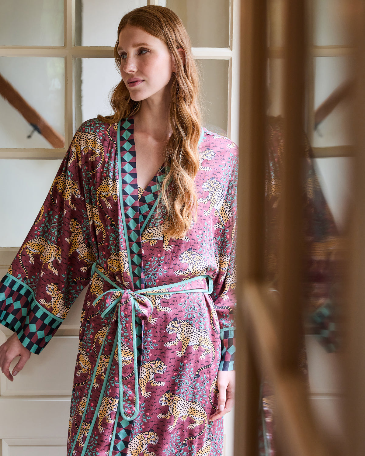 Front view of the Bagheera Raisin Eco Satin robe, showing the wrap closure, tie belt, long sleeves, and contrasting geometric trim.