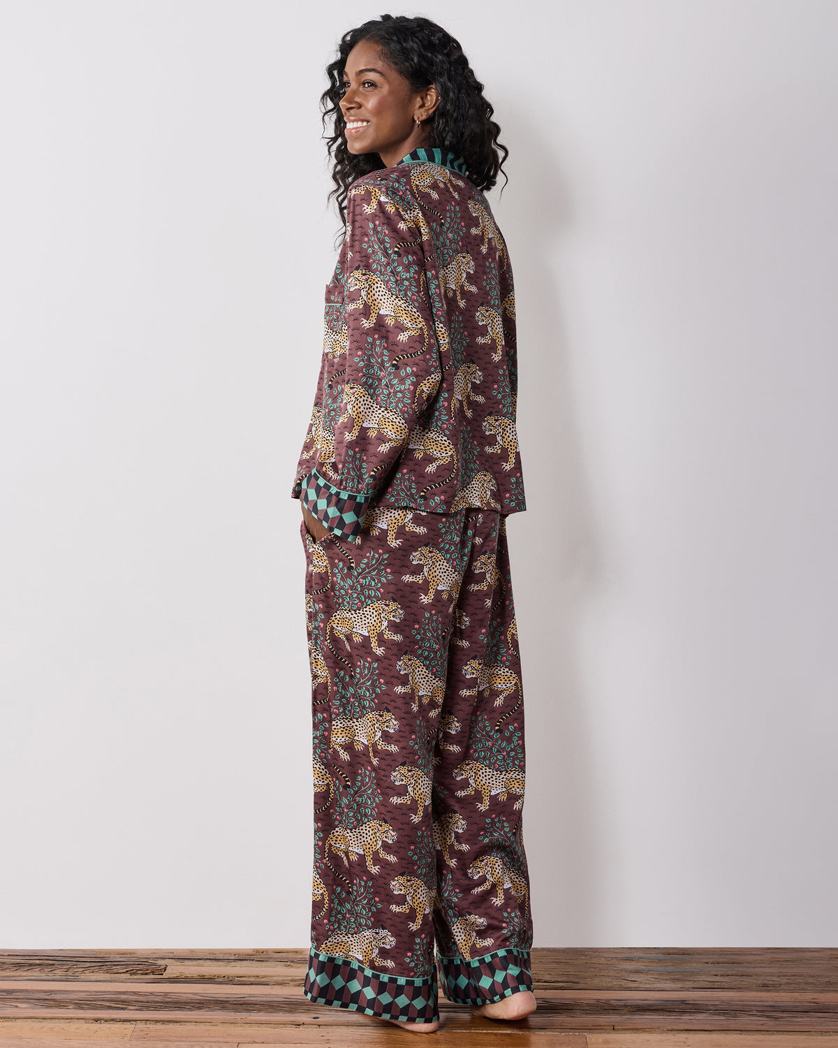 Back three-quarter view of a person wearing the raisin Bagheera leopard-print pajama set, showing the top and wide-leg pants.