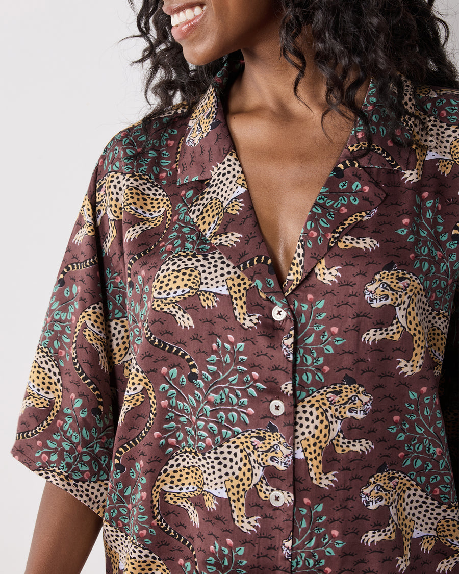 Close-up front view of the cropped button-down pajama top in the Raisin leopard-and-flora print, showing the collar, short sleeves, and buttons.