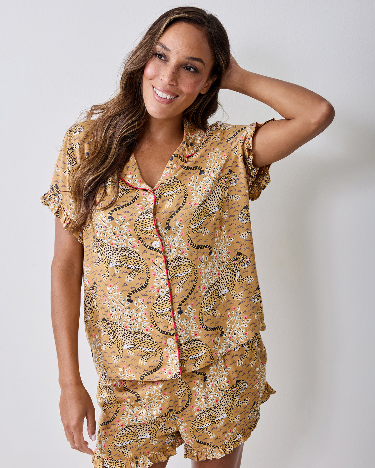 Front view of a person wearing the tobacco Bagheera leopard-print ruffle short pajama set.