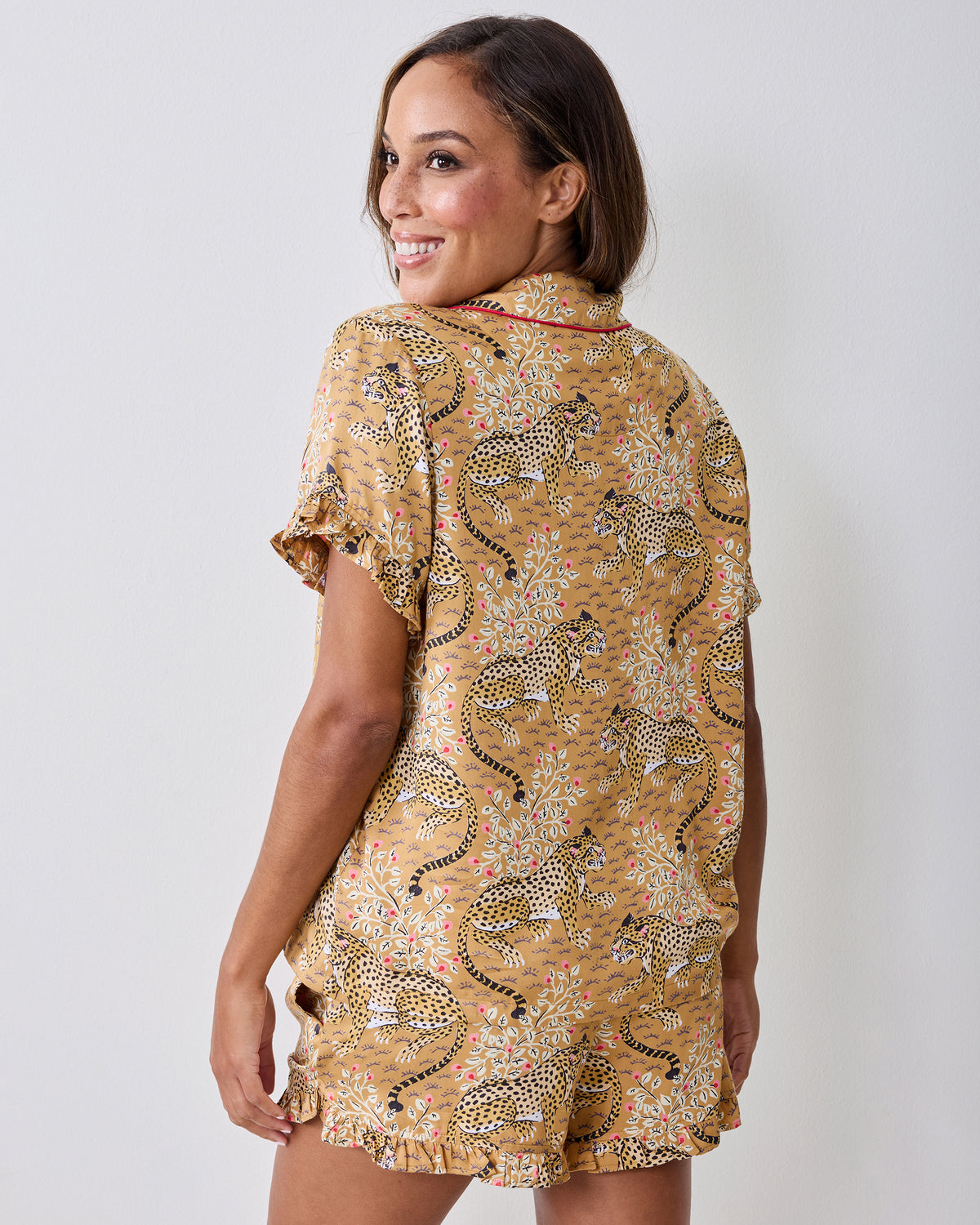 Back view of a person wearing the tobacco Bagheera leopard-print ruffle short pajama set.