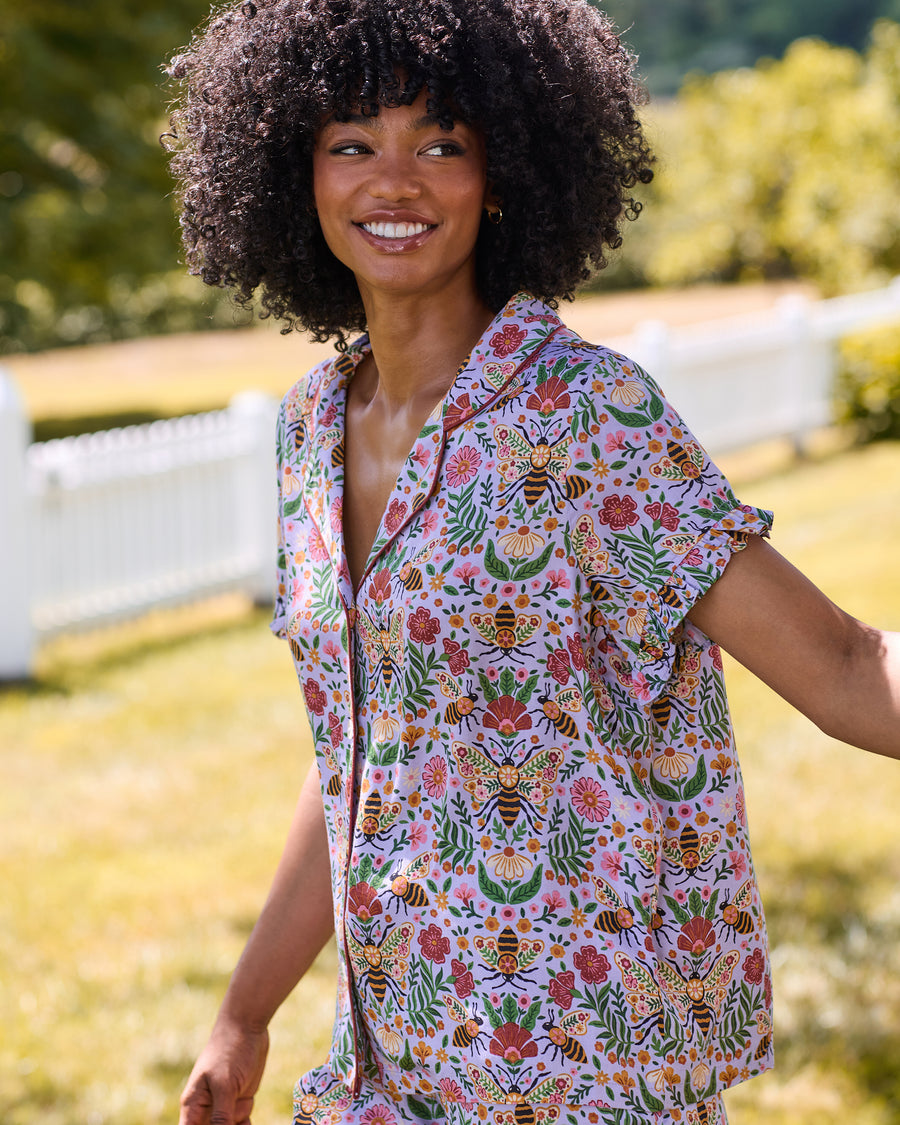 Person wearing the lavender Bee Tapestry ruffle short pajama set with flutter sleeves and bee-and-floral print.