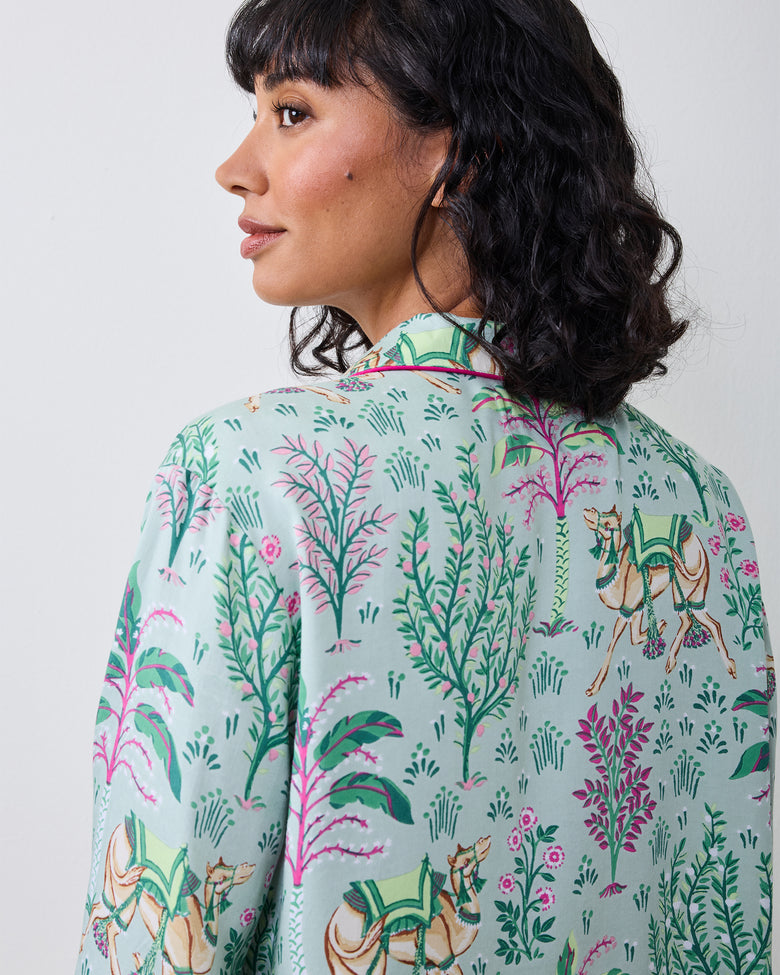 Close-up back view of the Avocado Camel's Courtyard pajama top showing botanical and camel motifs.
