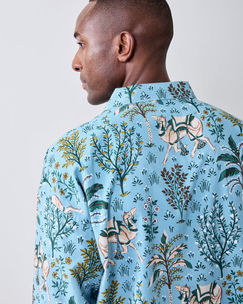 Back view of a slate blue long-sleeve pajama shirt with camel and desert botanical print.