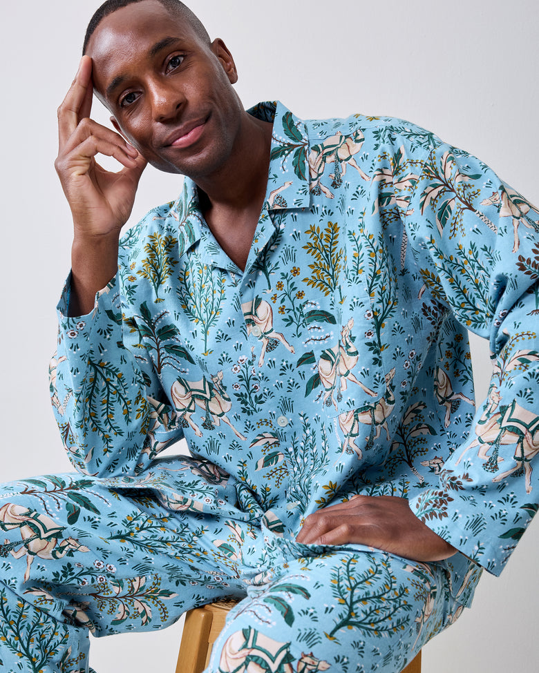 Front view of a slate blue long-sleeve pajama shirt and pants set with camel and botanical print.