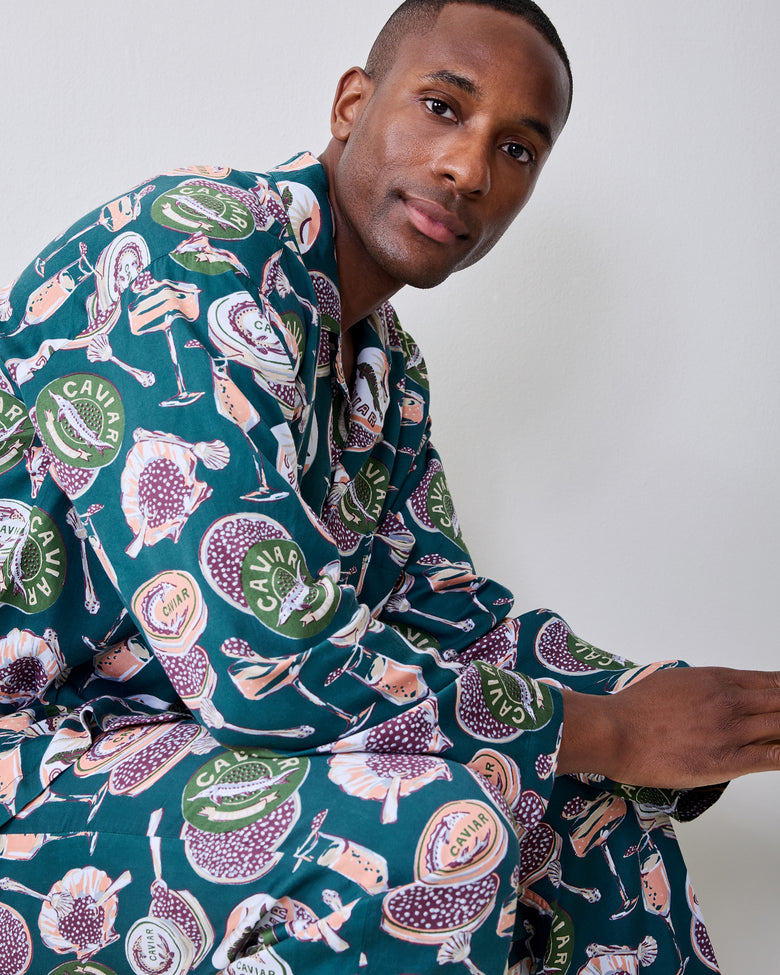 Close view of the pajama set’s dark teal caviar-and-champagne print on the top and pants.