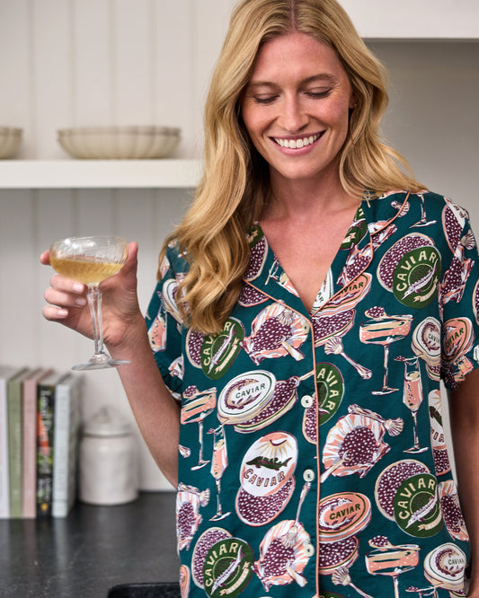 Close view of the Peacock Feather Champagne & Caviar short pajama set with caviar-themed prints and contrasting piping.