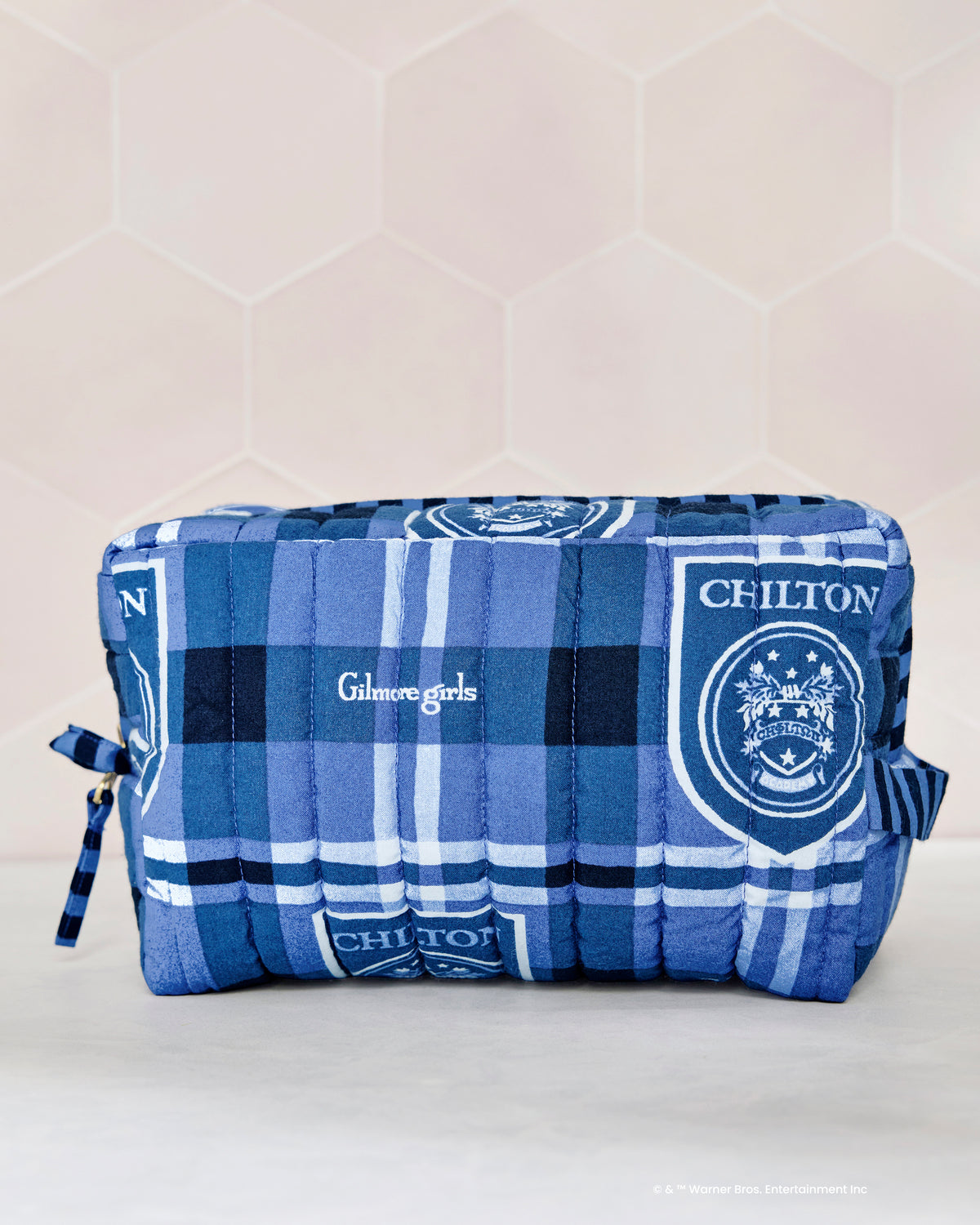 Front view of the blue plaid quilted pouch showing Gilmore Girls text and Chilton crest motifs.