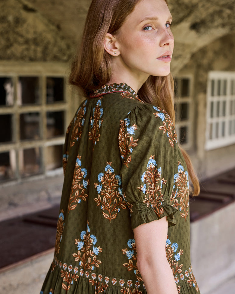 Back three-quarter view of the Colorado Wildflowers Bella Dress, showing the floral print, short sleeve, collar, and gathered skirt.