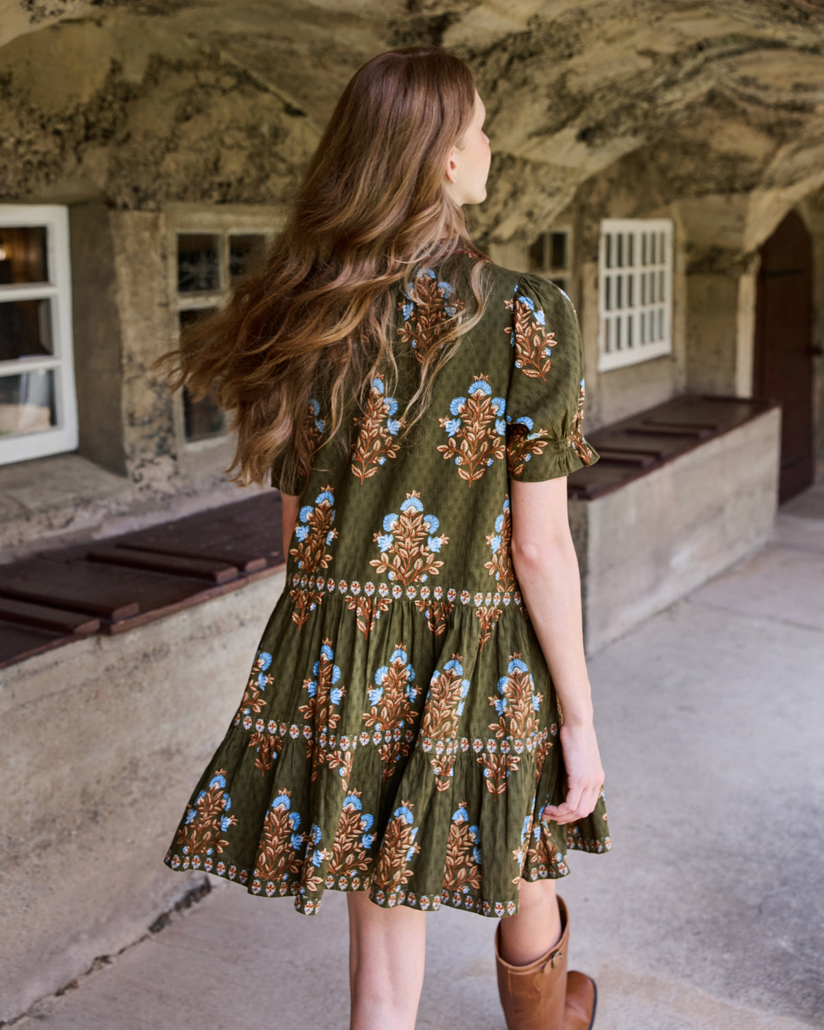 Back view of the Colorado Wildflowers Bella Dress in deep olive, showing the floral print, short sleeves, and tiered skirt.