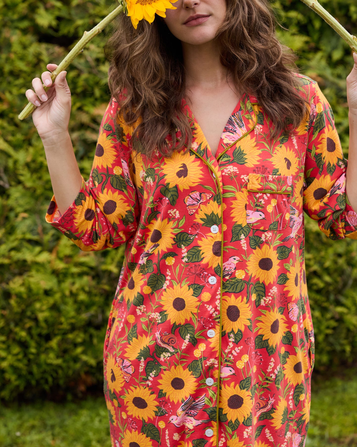 Close view of the orange floral sleep shirt showing its notched collar, button front, chest pocket, and patterned sleeves.