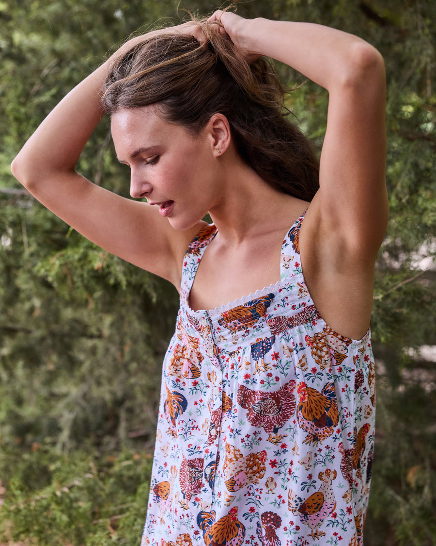 Close-up of the floral chicken-print sleeveless nightgown, showing its straps and neckline.