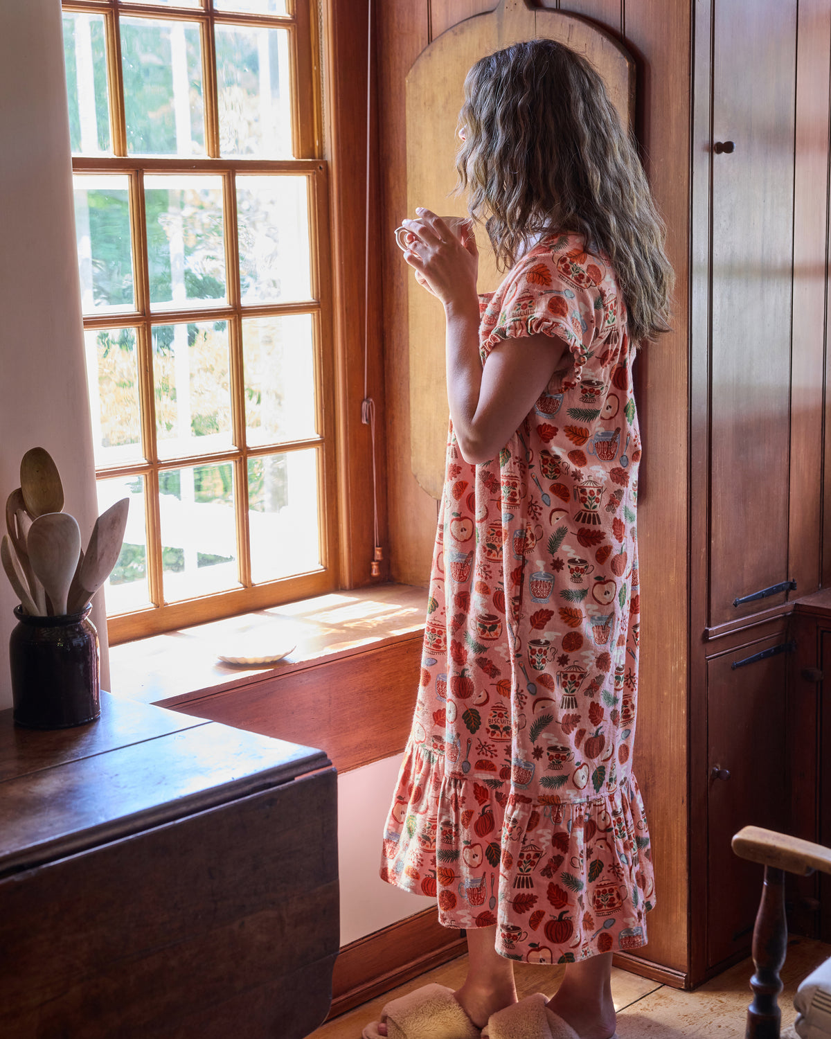 Back three-quarter view of the Autumn Cafe nightgown with short sleeves, a gathered back yoke, and ruffled hem.