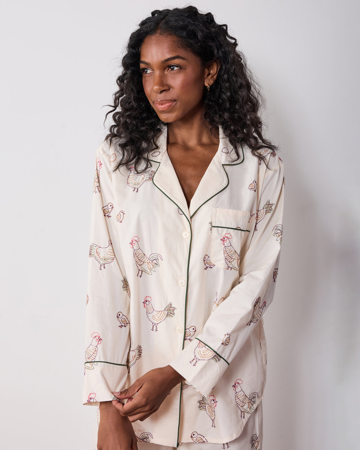 Model wearing the Embroidered Hens long pajama top with a button front, chest pocket, and hen and chick embroidery.
