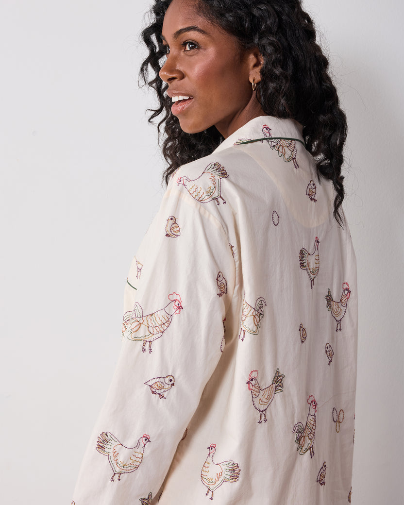 Back view of the buff embroidered-hen long pajama shirt with green piping.