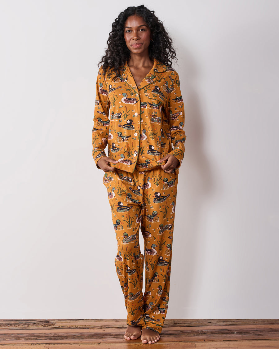 Front view of the mustard Duck Pond long pajama set with a duck print, button-down top, and full-length pants.