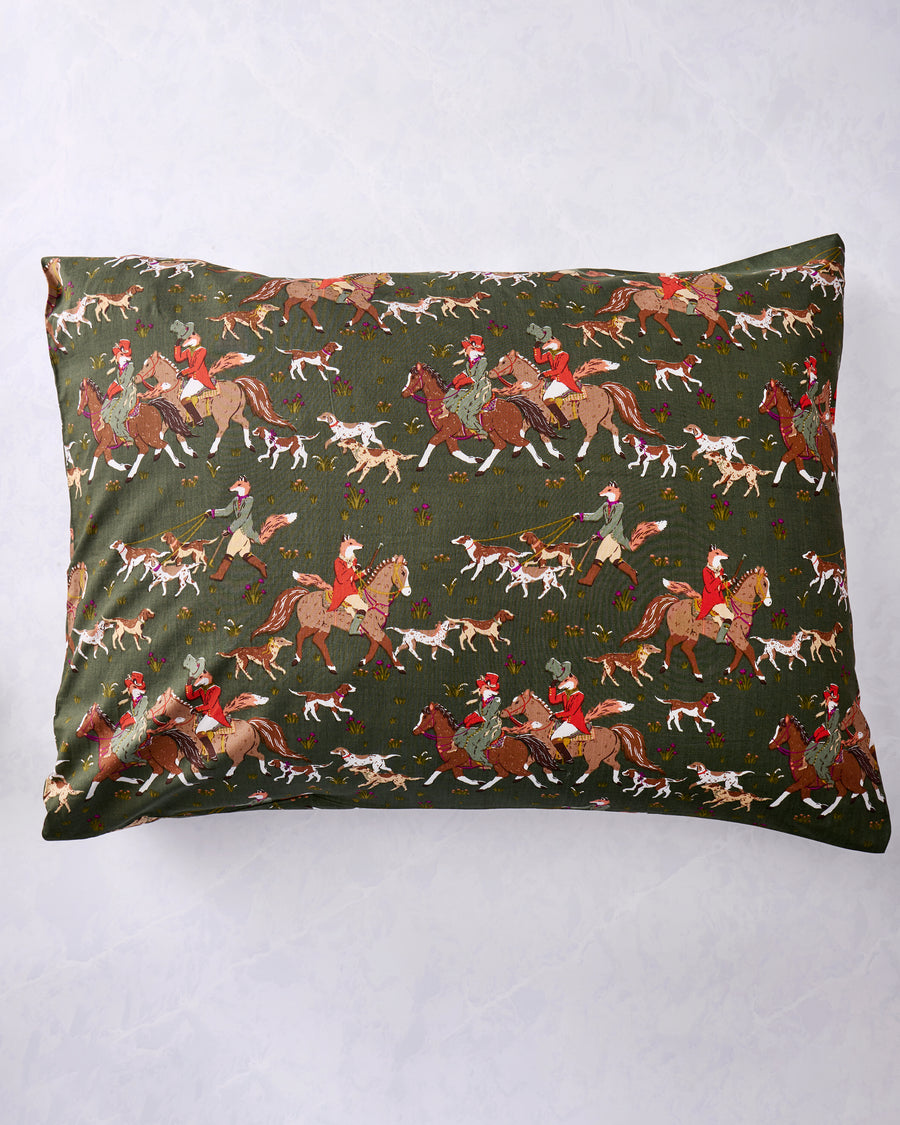 Pine green pillowcase laid flat, covered with a repeating print of foxes, hounds, and riders on horseback.