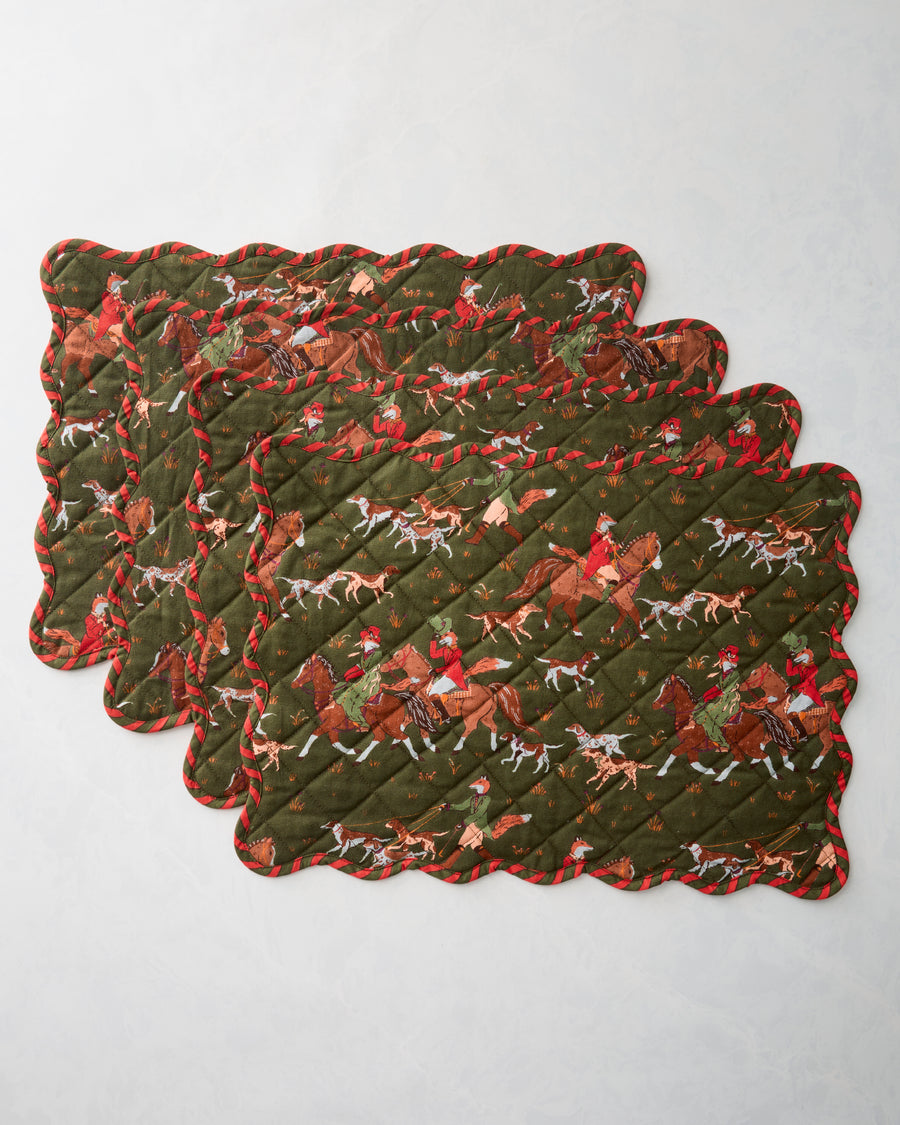 Four scalloped quilted placemats layered in a stack, showing the Fox & Hounds horse-and-hounds print and striped edging.