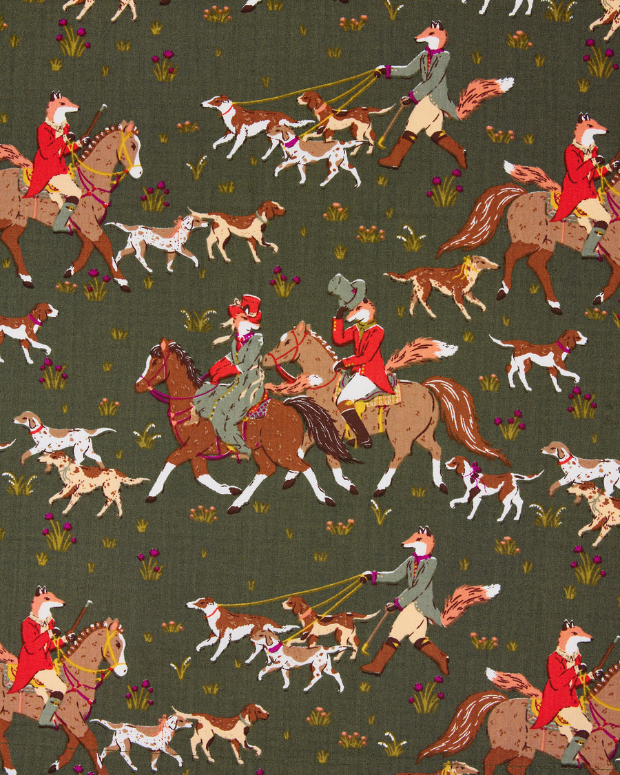 Close-up of the Pine Grove print showing foxes riding horses and walking hounds across a green background.