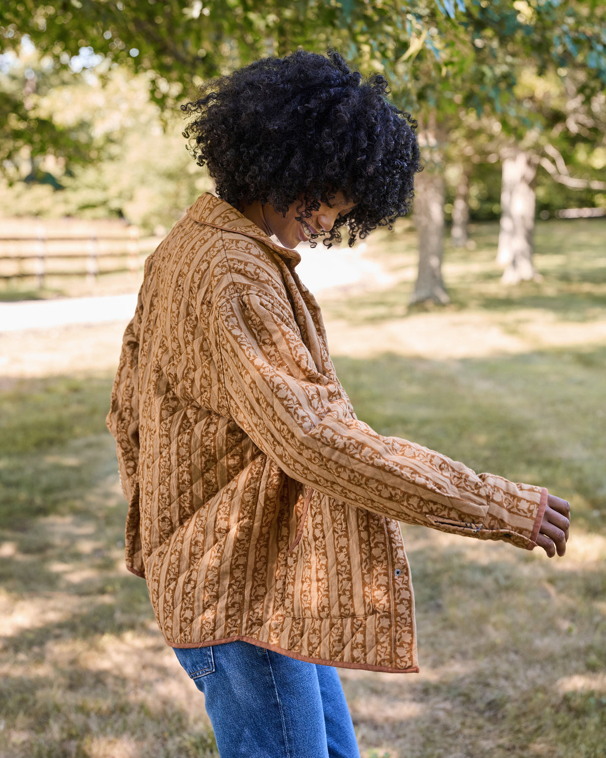 Back view of a patterned quilted jacket showing its vertical stripe design.