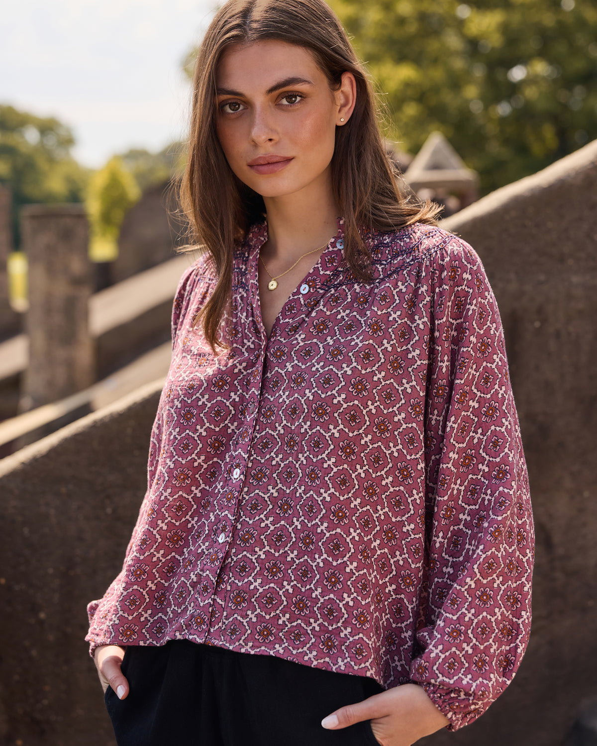 Front view of the patterned long-sleeve Aspen blouse with a buttoned neckline.