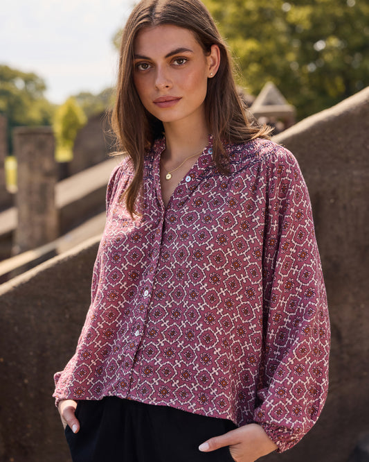 Front view of the patterned long-sleeve Aspen blouse with a buttoned neckline.