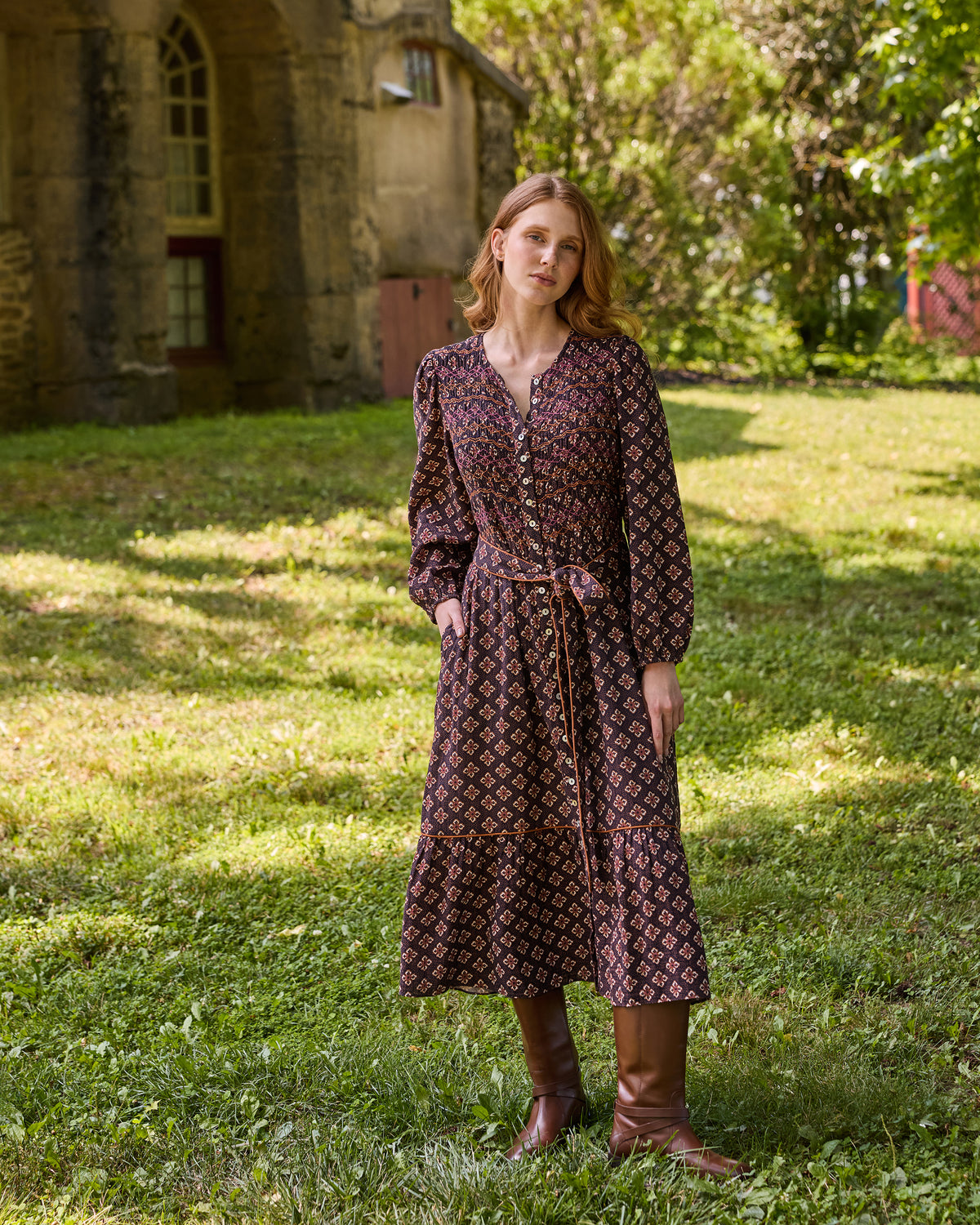 Full-length front view of the patterned Shay midi dress with a buttoned neckline and waist tie.