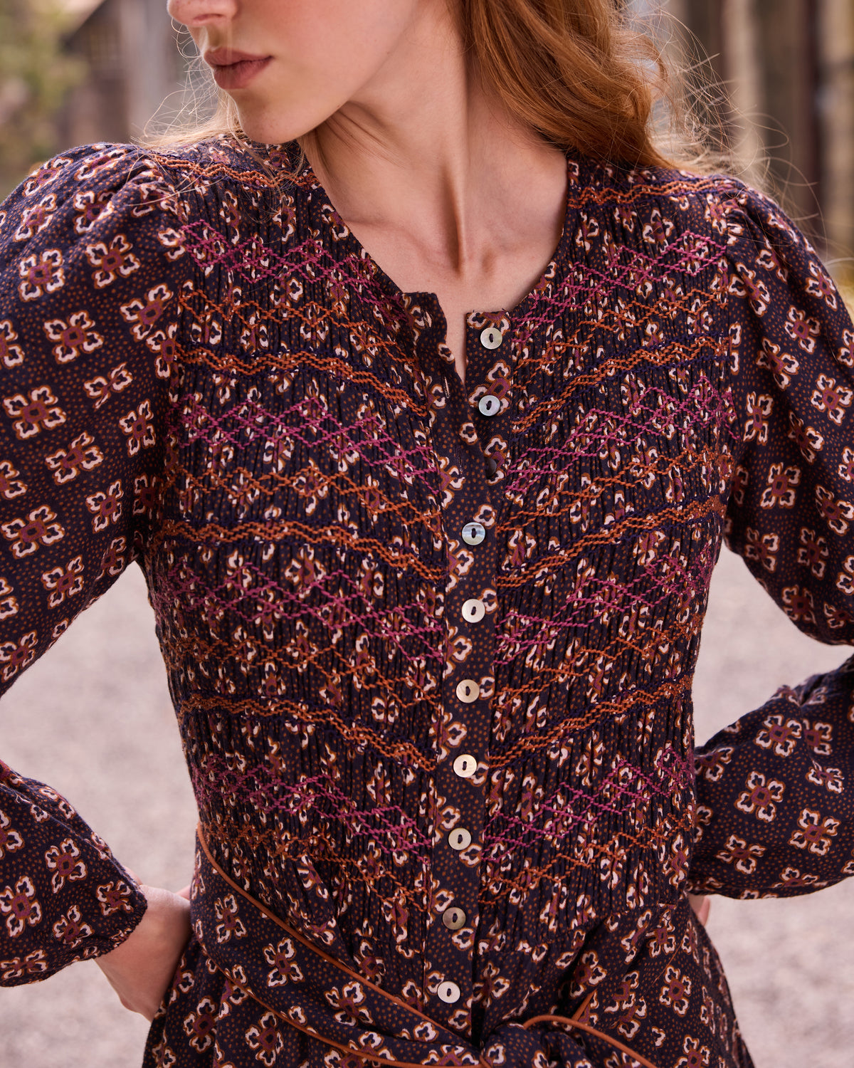 Close-up of the Shay dress bodice showing gathered detailing, patterned sleeves, and front buttons.