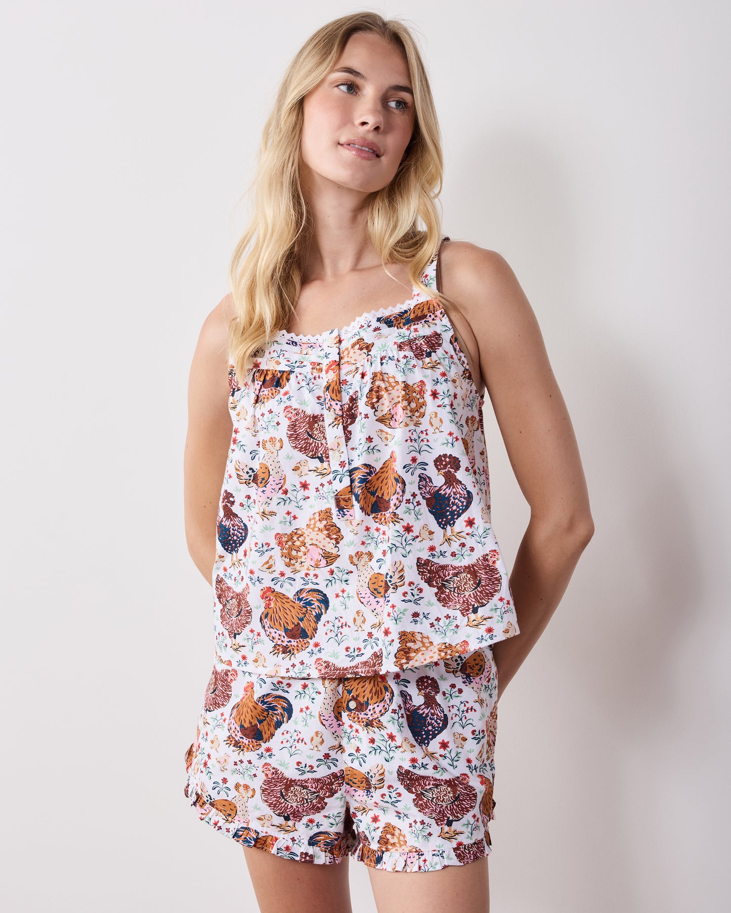 Front view of a printed short pajama set with a camisole-style top and ruffled shorts.