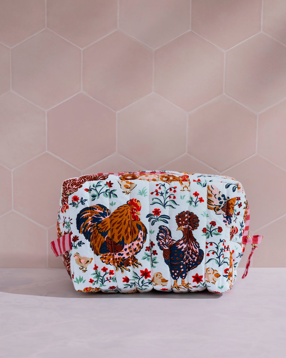 Front view of the Must Love Chickens quilted pouch, featuring two large illustrated chickens surrounded by flowers and small animals.