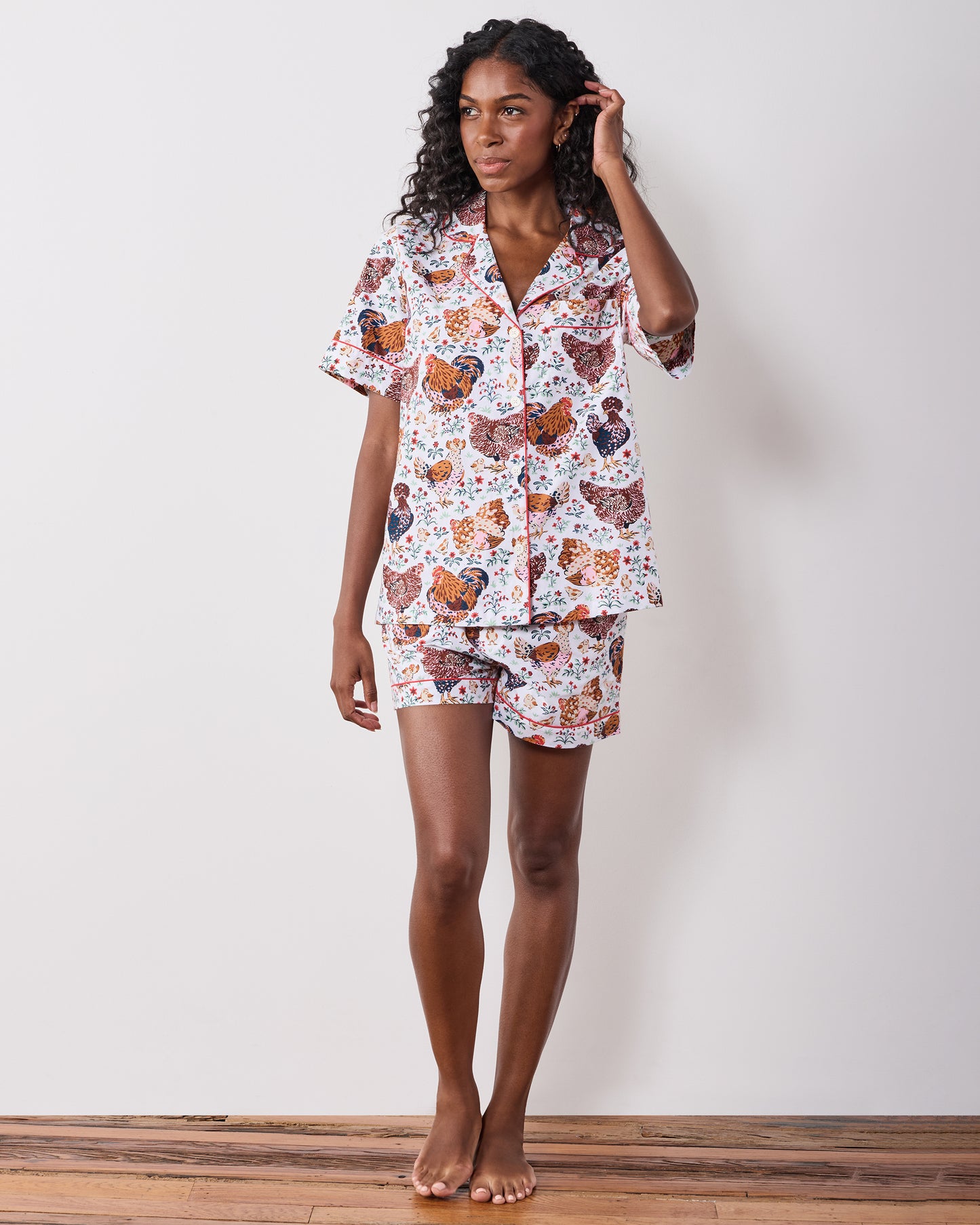 Full-length front view of a short chicken-print pajama set with a collared short-sleeve top and shorts.