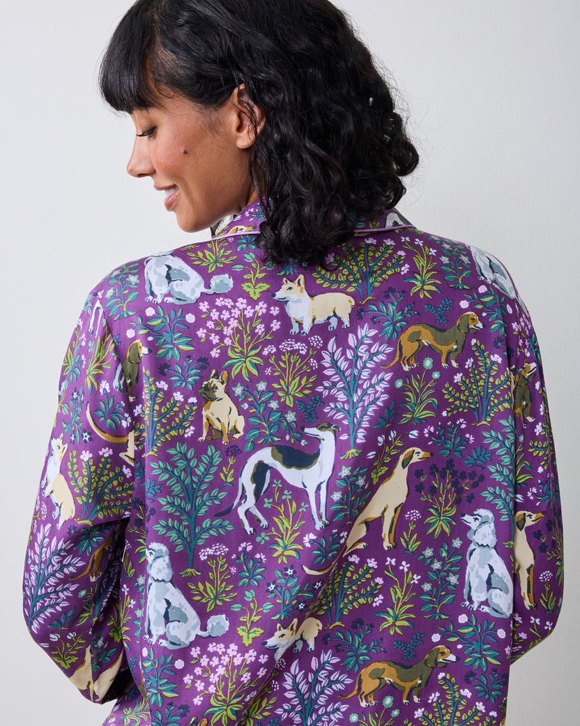 Close-up back view of the purple dog-and-floral print pajama top, showing its collar, long sleeves, and detailed animal pattern.