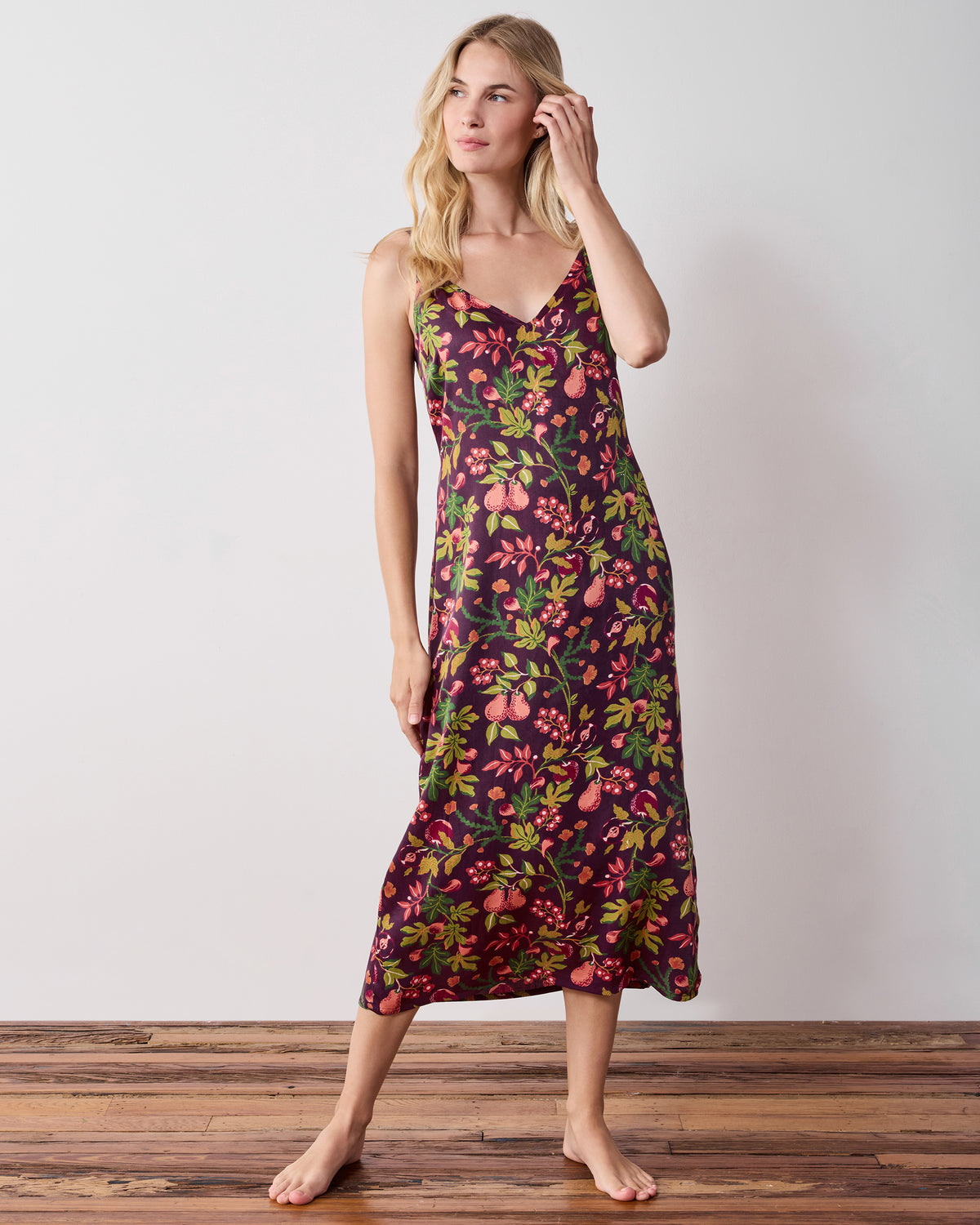 Full-length front view of a person wearing a plum floral-print sleeveless nightie
