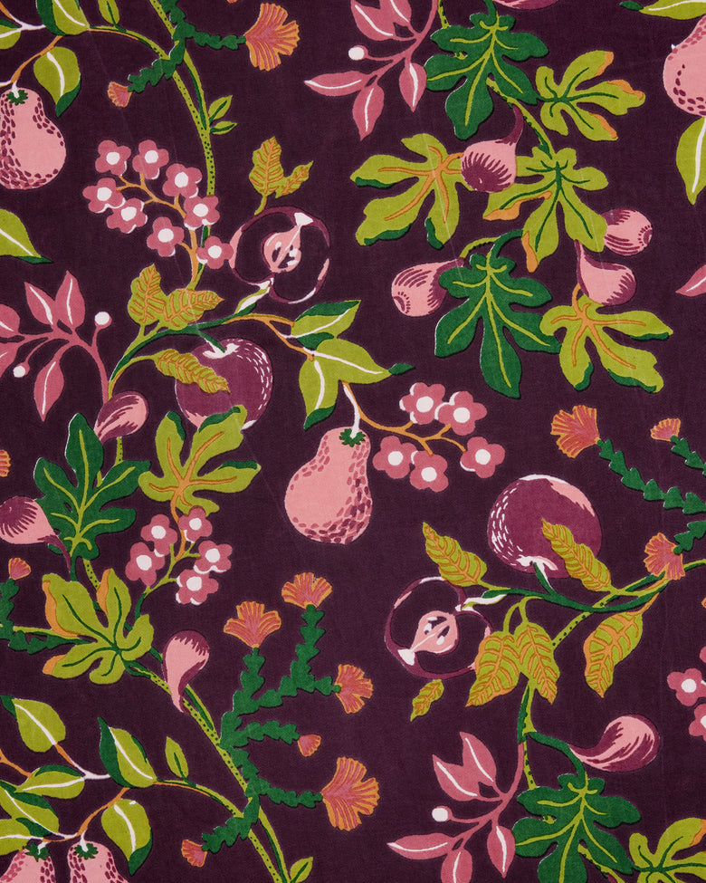 Close-up of the Pomme & Poire apron’s plum fabric print with fruit, flowers, leaves, and vines.