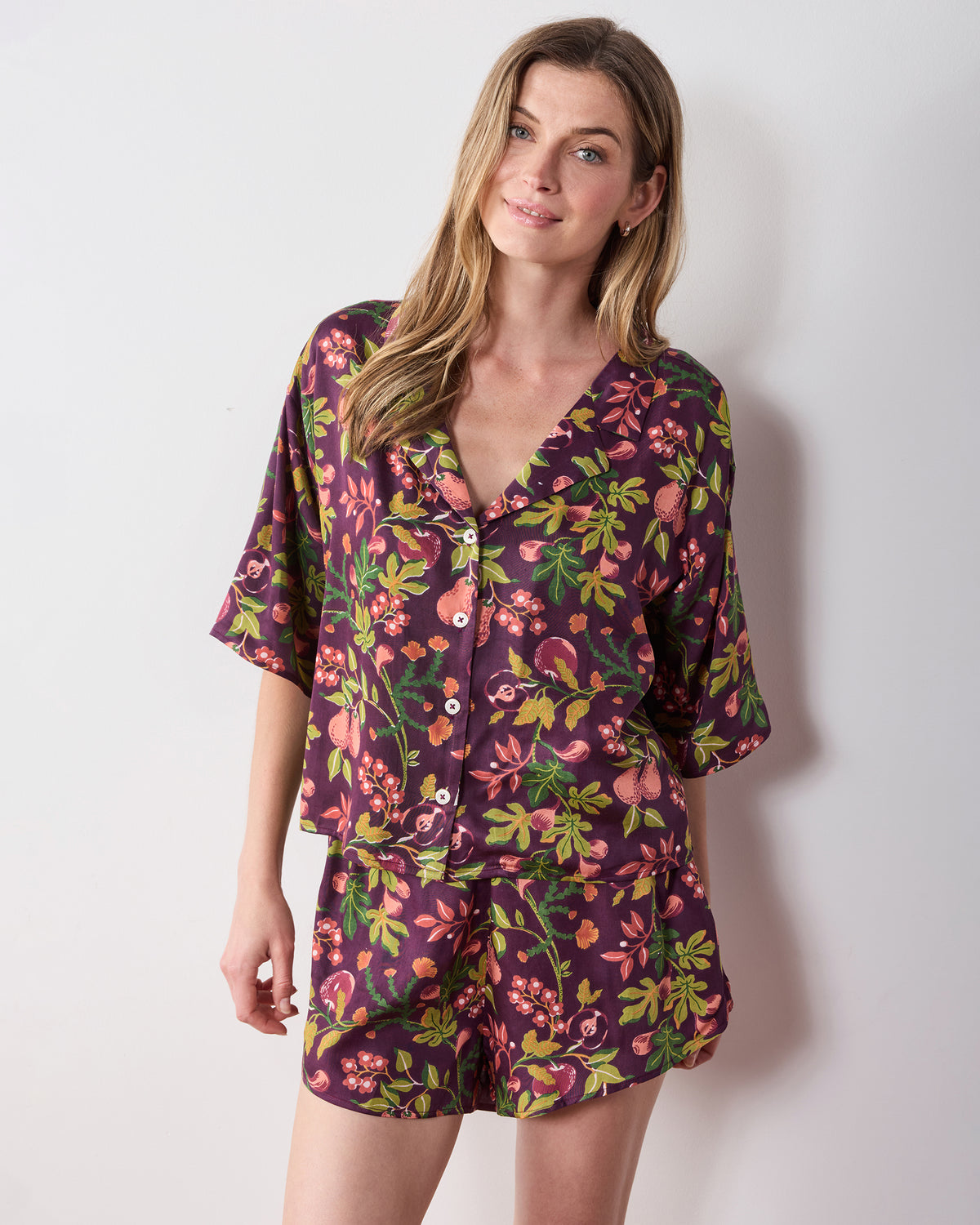 Closer front view of the plum Pomme & Poire Sweet Dreams short pajama set with a V-neck button-front top and matching shorts.