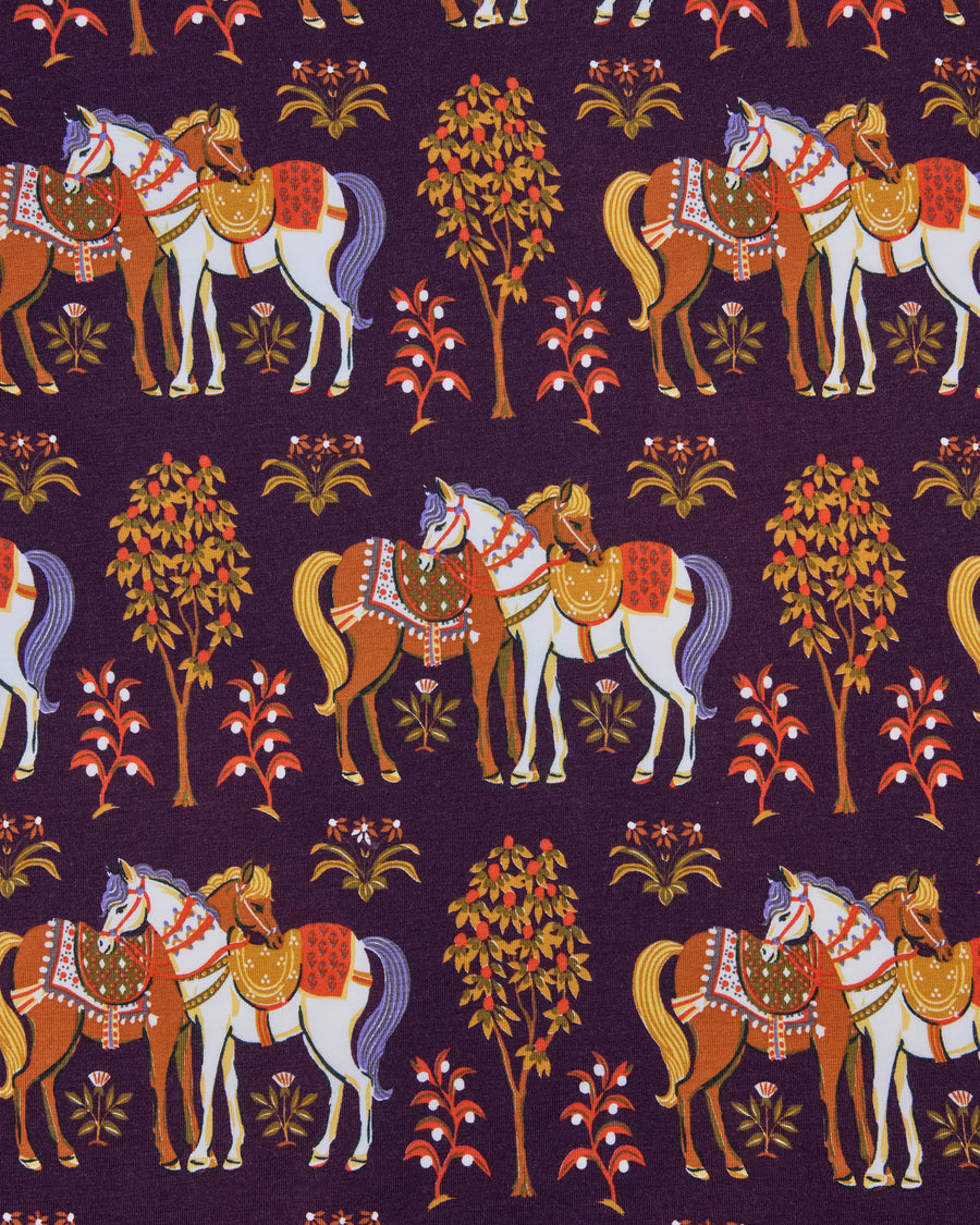Close-up of the deep aubergine Queen’s Horses print, showing pairs of decorated horses, trees, and small plants.