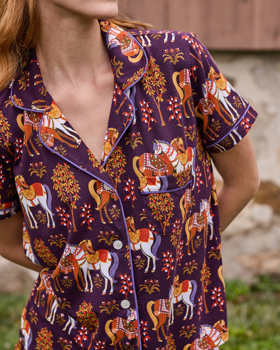 Close-up of the short-sleeve Queen’s Horses pajama top with horse-and-tree print, collar, pocket, and buttons.