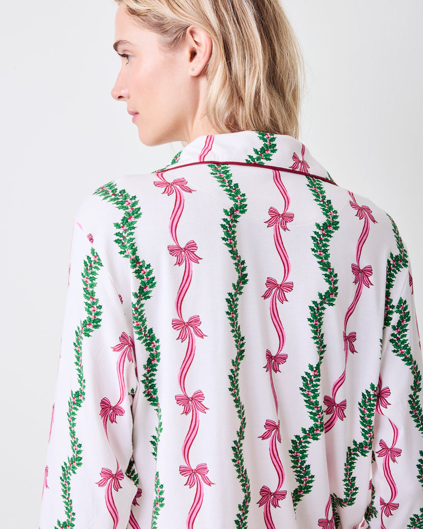 Back view of the Ribbons & Bows long pajama top in Vanilla Cream with vertical green garlands and pink bows.