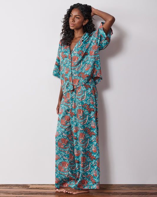 Side view of the teal patterned button-front pajama set with wide-leg pants.