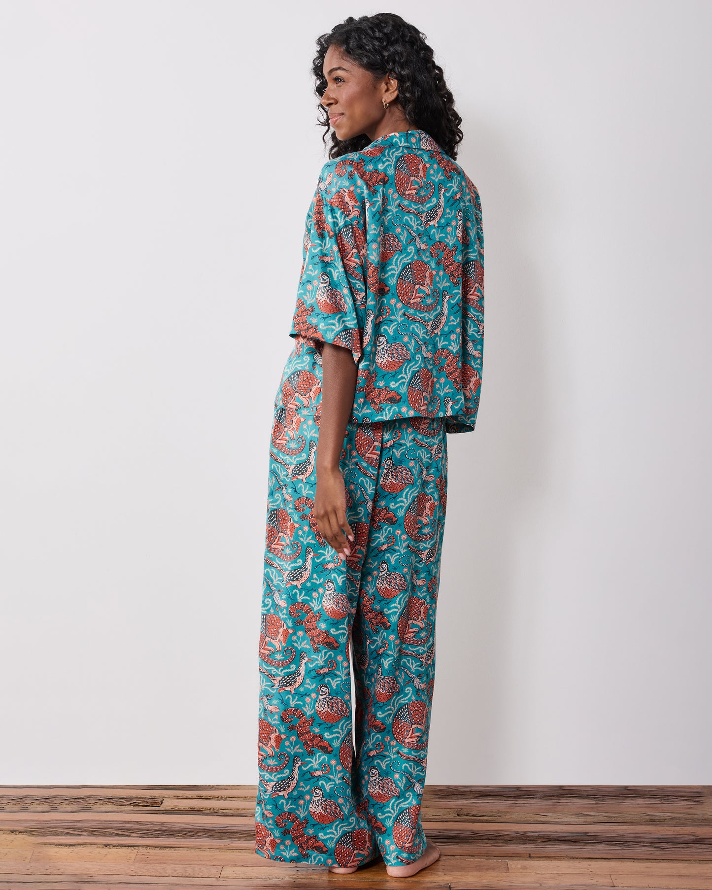 Back view of the teal patterned pajama set with a short-sleeve top and wide-leg pants.